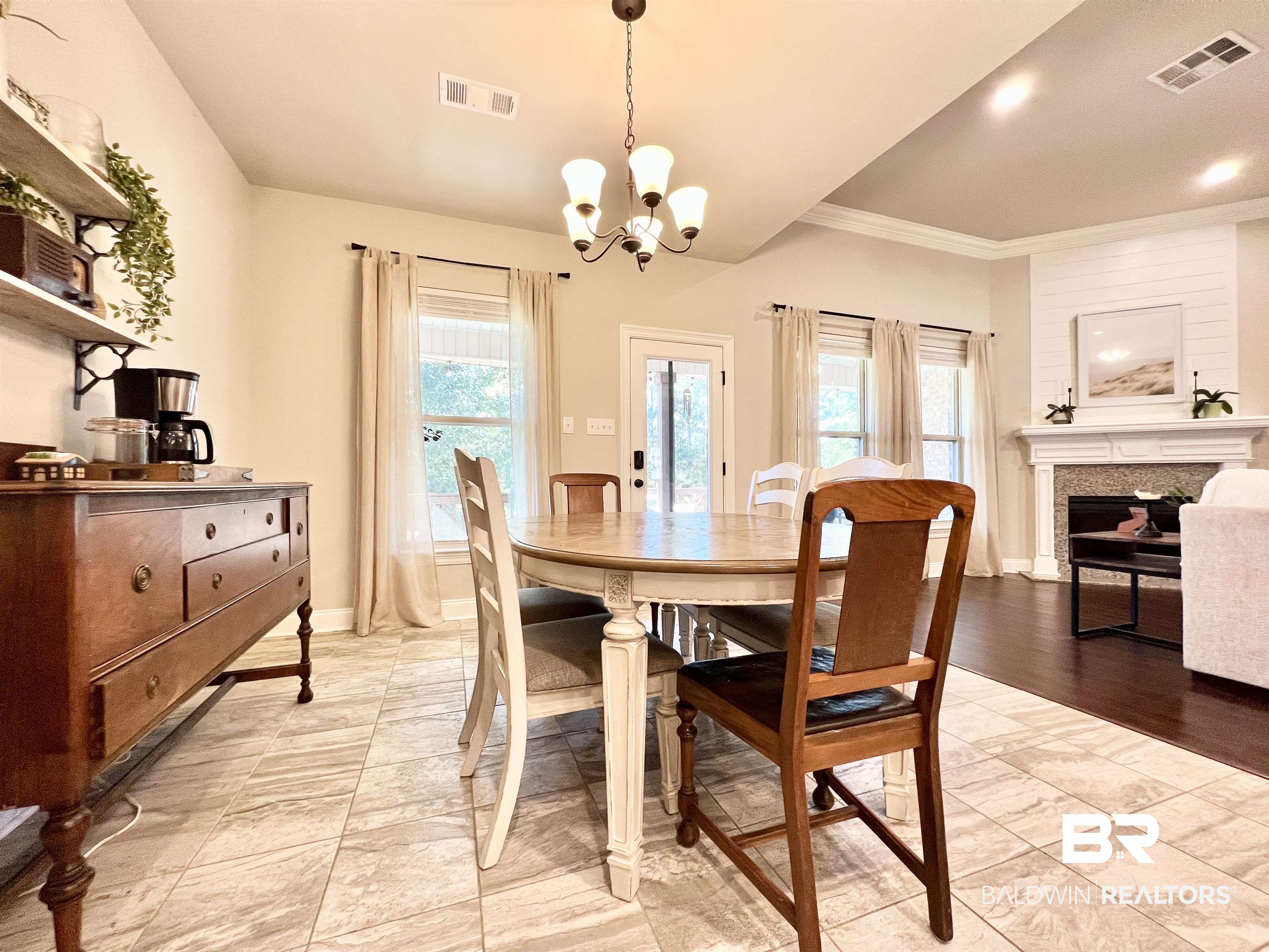 32290 Calder Court Daphne, AL 36527 - Photo 16 of 59 Dining room with ornamental molding, light hardwood / wood-style flooring, and a notable chandelier