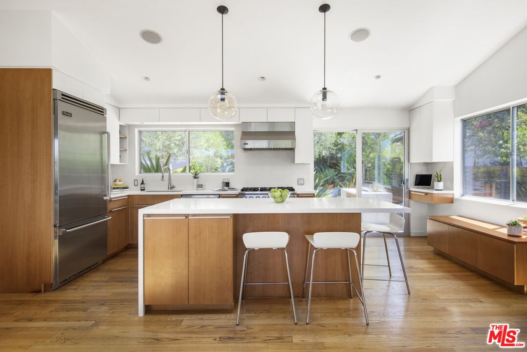 1423 Elevado Street Los Angeles, CA 90026 - Photo 11 of 51 a kitchen with stainless steel appliances granite countertop a sink a stove and a refrigerator