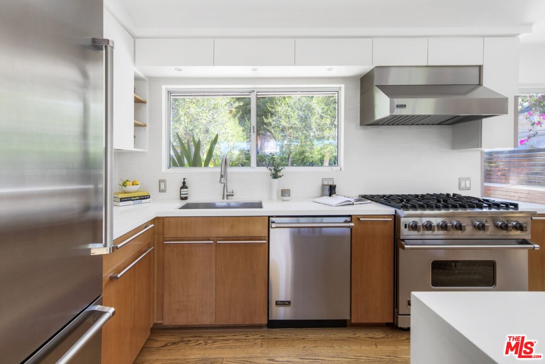 1423 Elevado Street Los Angeles, CA 90026 - Photo 12 of 51 a kitchen with stainless steel appliances granite countertop a sink stove and refrigerator