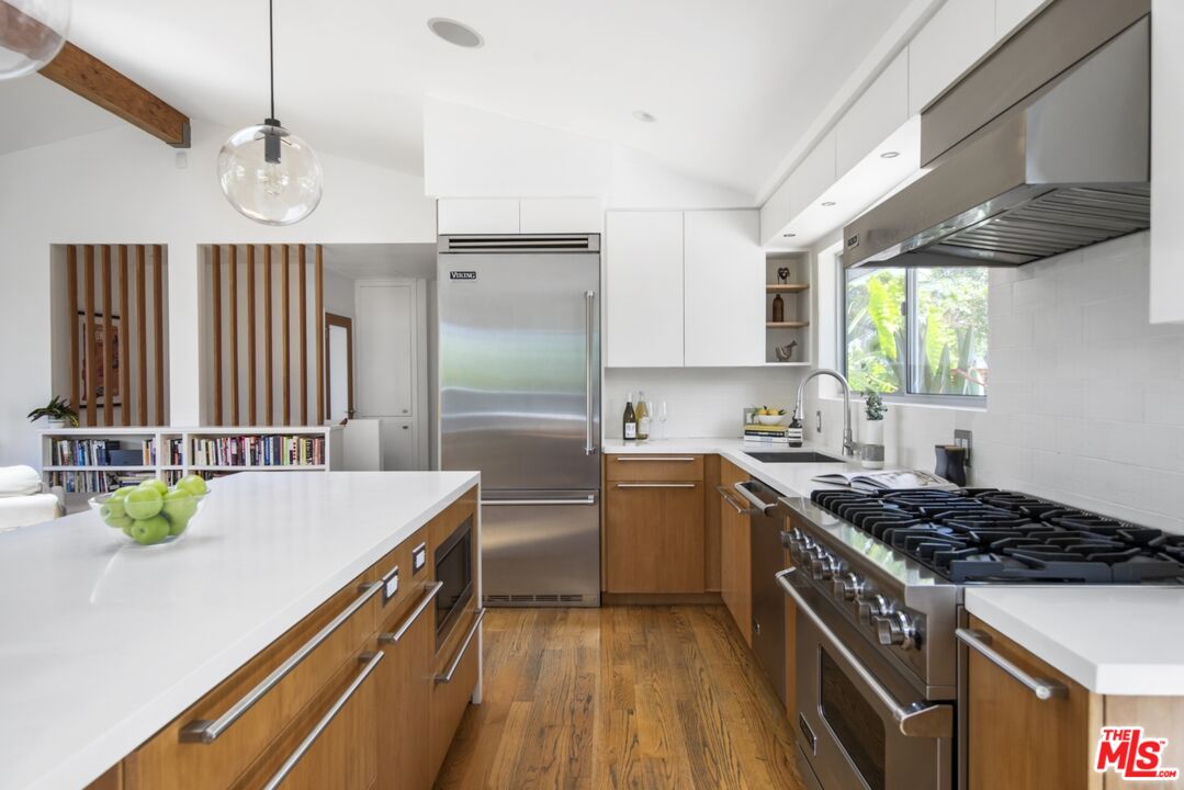 1423 Elevado Street Los Angeles, CA 90026 - Photo 13 of 51 a kitchen that has a sink a stove and a wooden cabinets