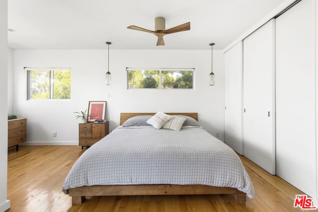 1423 Elevado Street Los Angeles, CA 90026 - Photo 20 of 51 a bedroom with a bed a dresser and a window