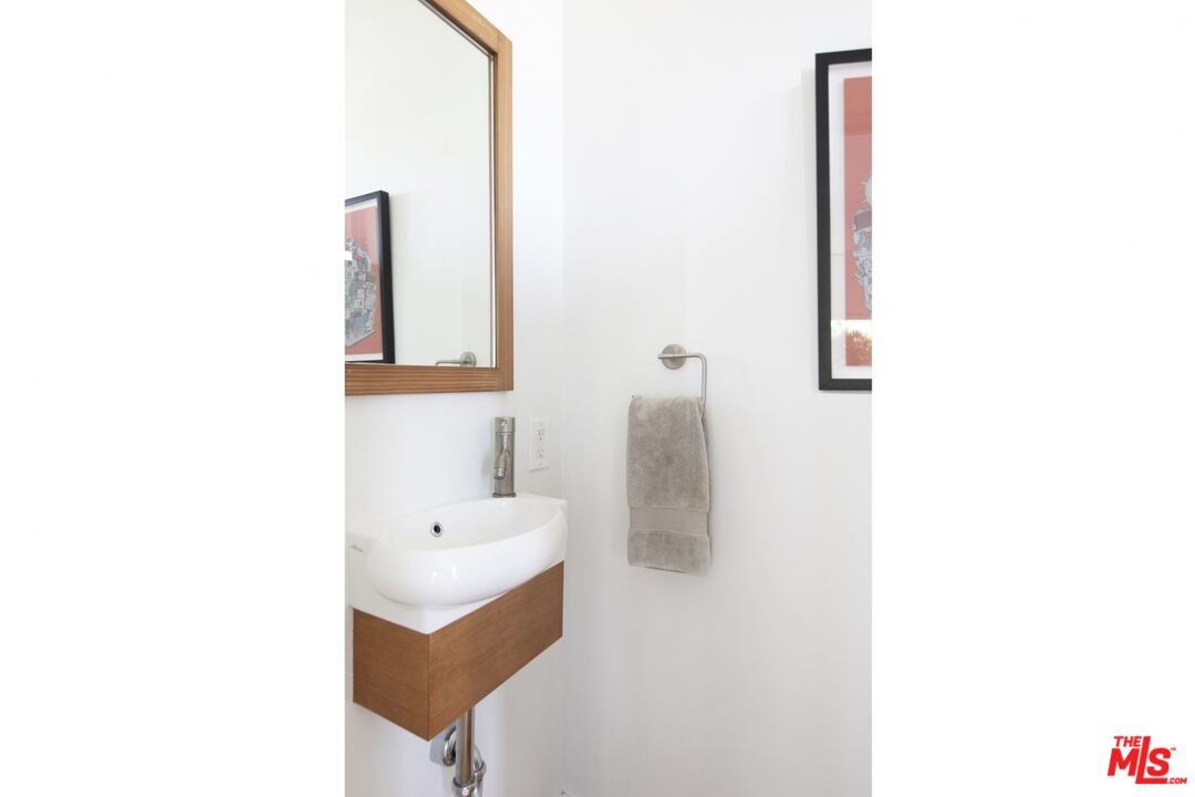 1423 Elevado Street Los Angeles, CA 90026 - Photo 22 of 51 a bathroom with a sink and a mirror