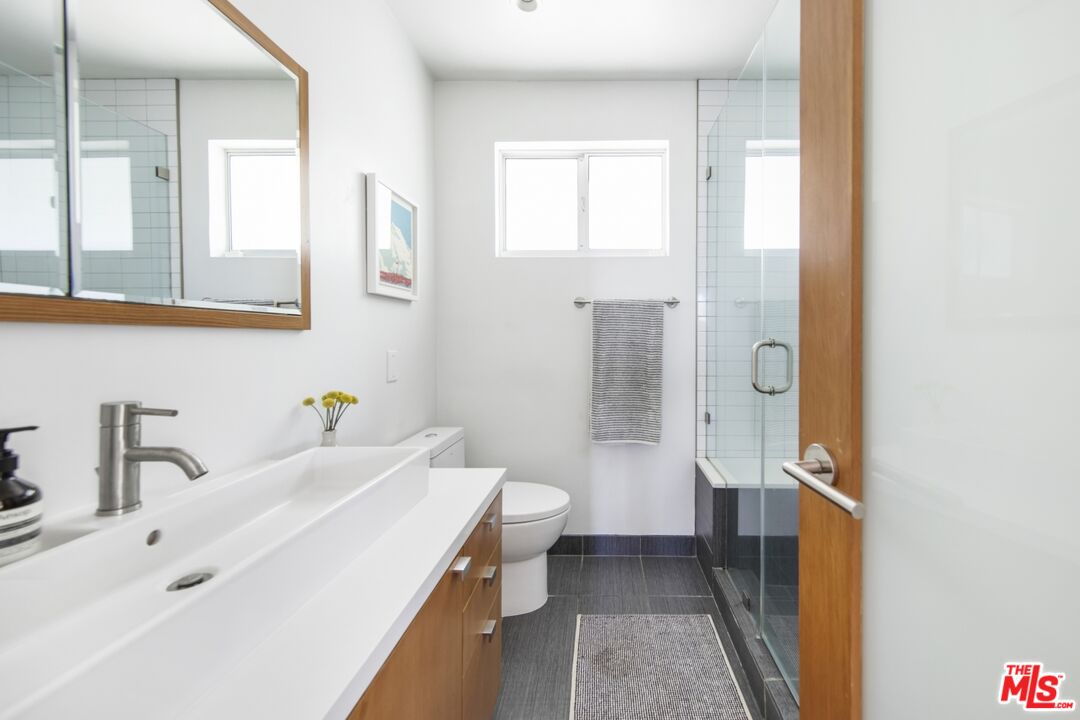 1423 Elevado Street Los Angeles, CA 90026 - Photo 25 of 51 a bathroom with a sink a toilet and a shower