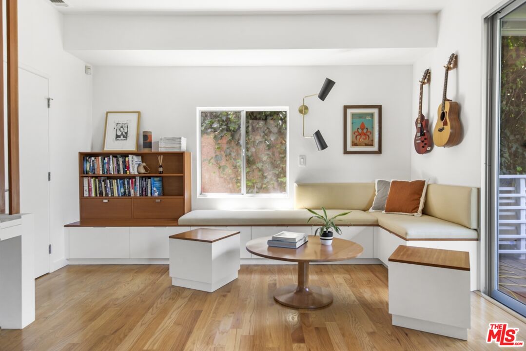 1423 Elevado Street Los Angeles, CA 90026 - Photo 30 of 51 a living room with furniture and a book shelf