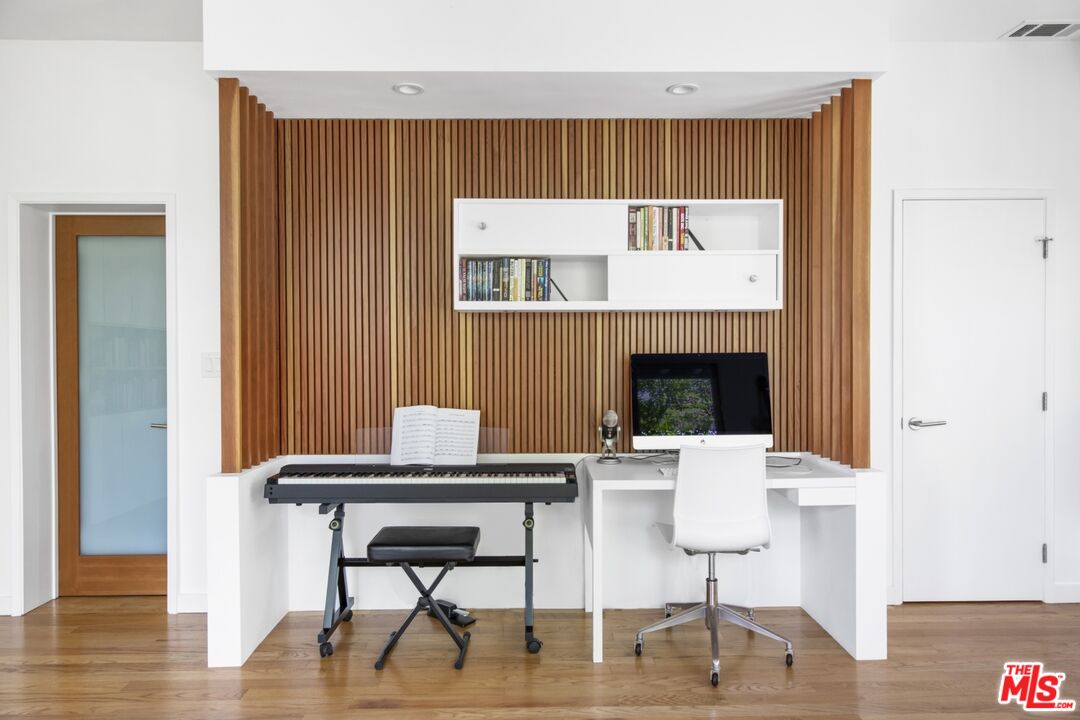 1423 Elevado Street Los Angeles, CA 90026 - Photo 33 of 51 a view of a dining room with furniture wooden floor and a fireplace