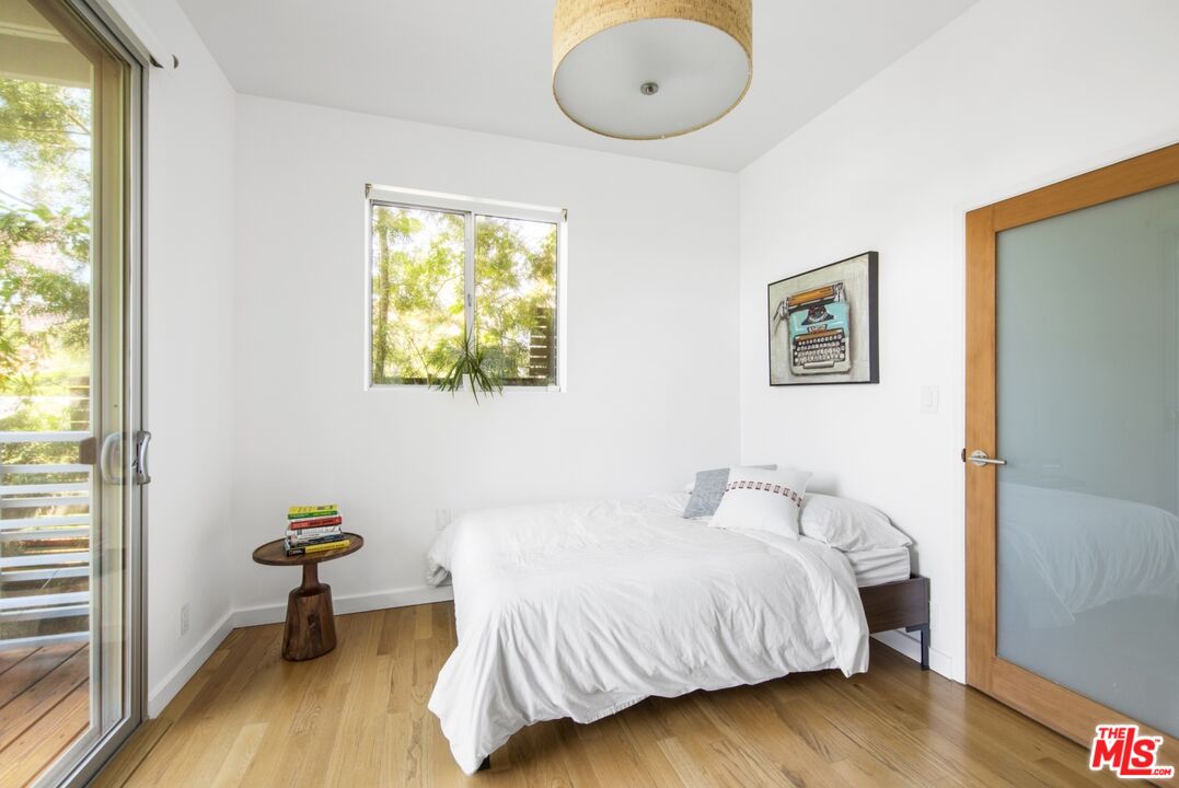1423 Elevado Street Los Angeles, CA 90026 - Photo 36 of 51 a bedroom with a bed and wooden floor