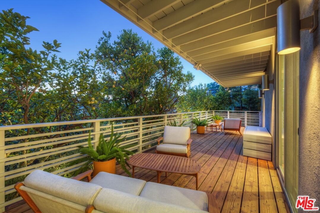 1423 Elevado Street Los Angeles, CA 90026 - Photo 38 of 51 a balcony with wooden floor and outdoor seating
