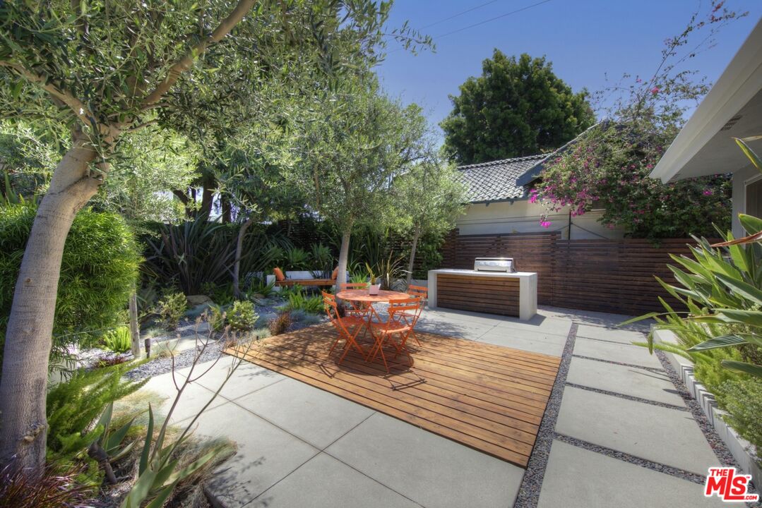 1423 Elevado Street Los Angeles, CA 90026 - Photo 46 of 51 a view of a patio with table and chairs potted plants with large tree