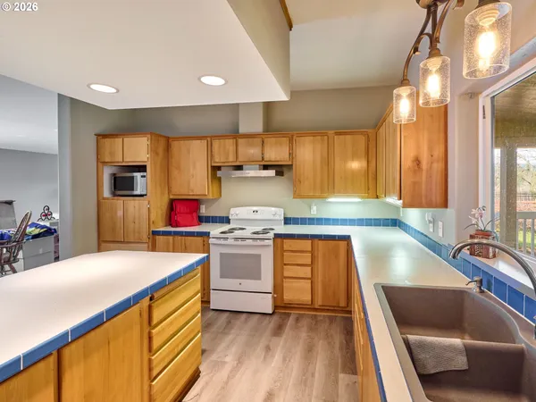 a kitchen with stainless steel appliances granite countertop a sink stove and cabinets