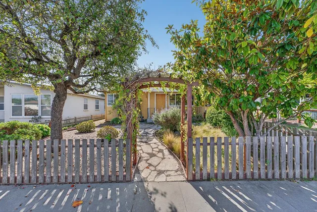 a view of a wooden fence next to a house