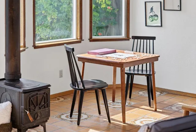 a view of a dining room with furniture and a window