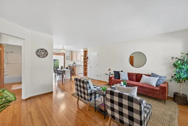 a living room with furniture and wooden floor