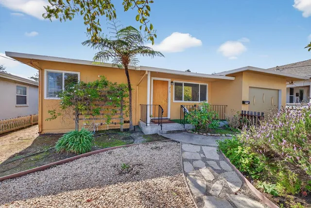 a front view of a house with garden