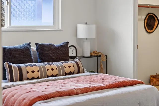 a bedroom with a bed and a window