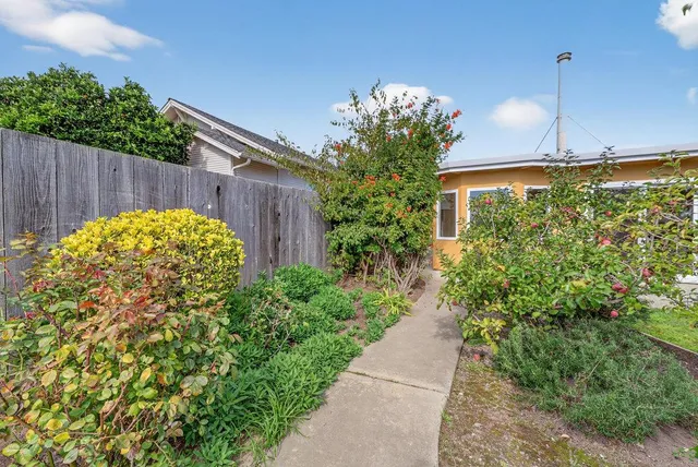 a view of a pathway of a building with a garden