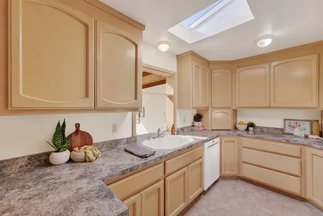 a kitchen with a sink cabinets and window
