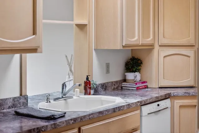 a bathroom with sink granite and a mirror