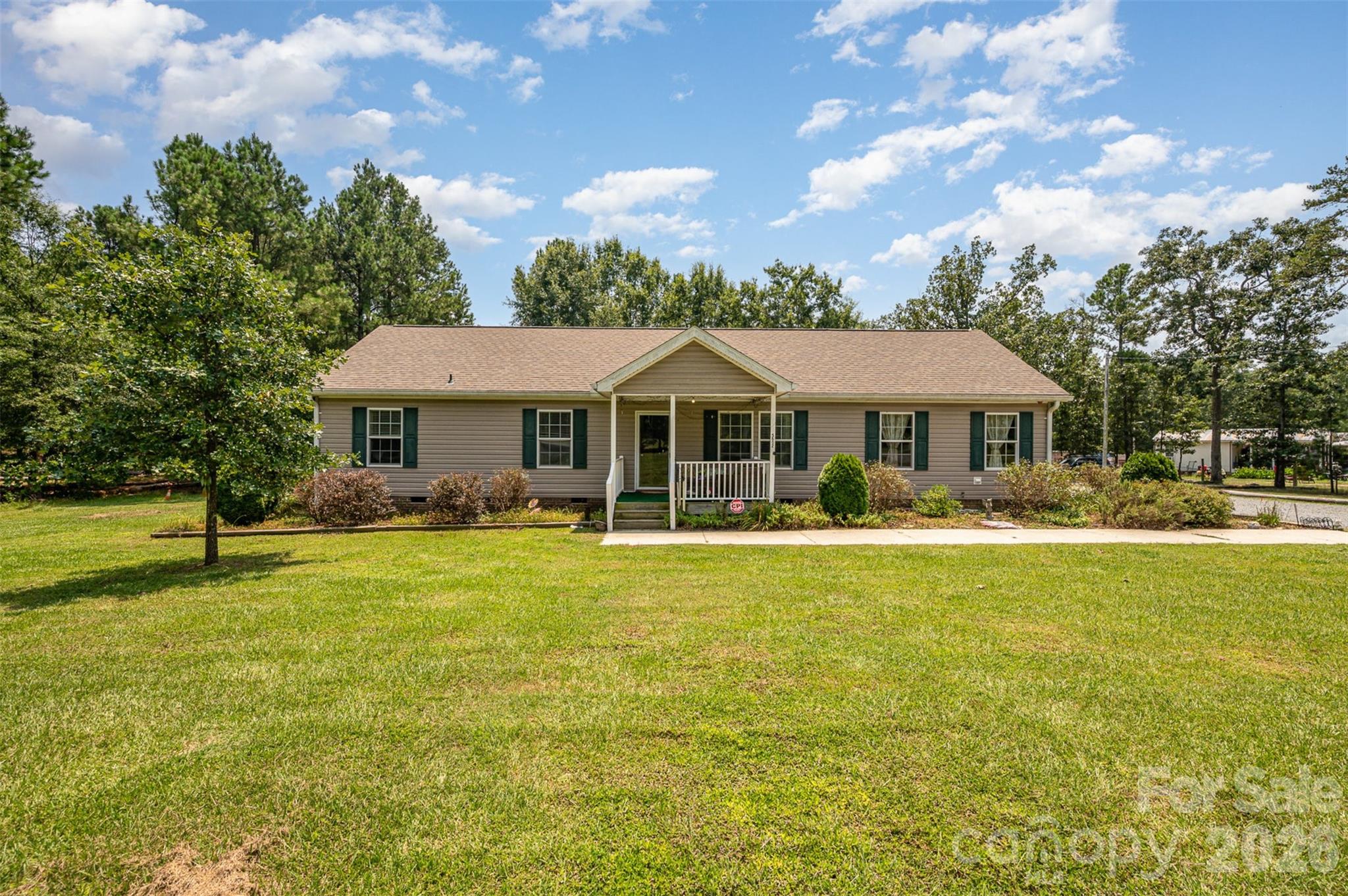 5602 Flint Ridge Marshville, NC 28103 - Photo 1 of 26 a front view of a house with swimming pool having outdoor seating