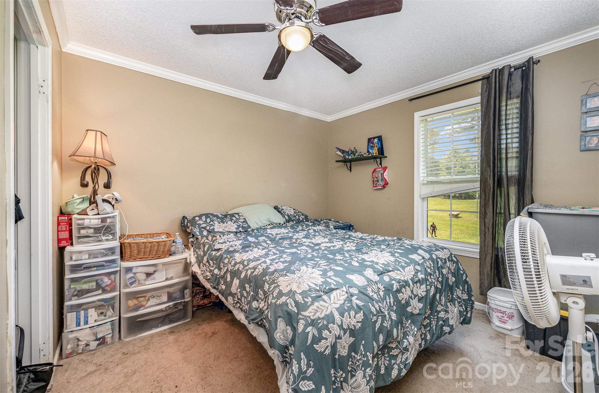 5602 Flint Ridge Marshville, NC 28103 - Photo 11 of 26 a bedroom with a bed and a chandelier