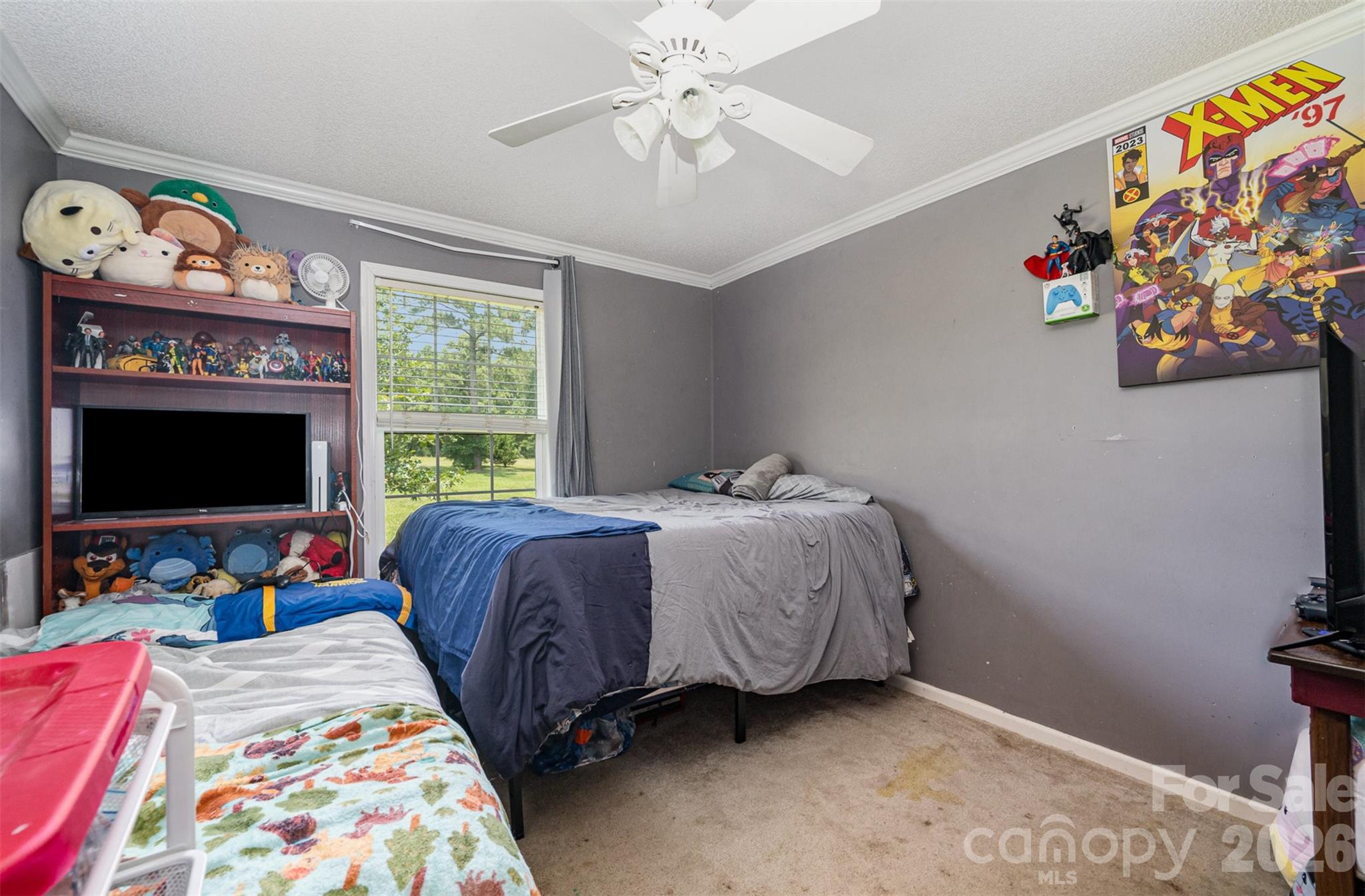 5602 Flint Ridge Marshville, NC 28103 - Photo 12 of 26 a bedroom with a bed a flat screen tv and a window
