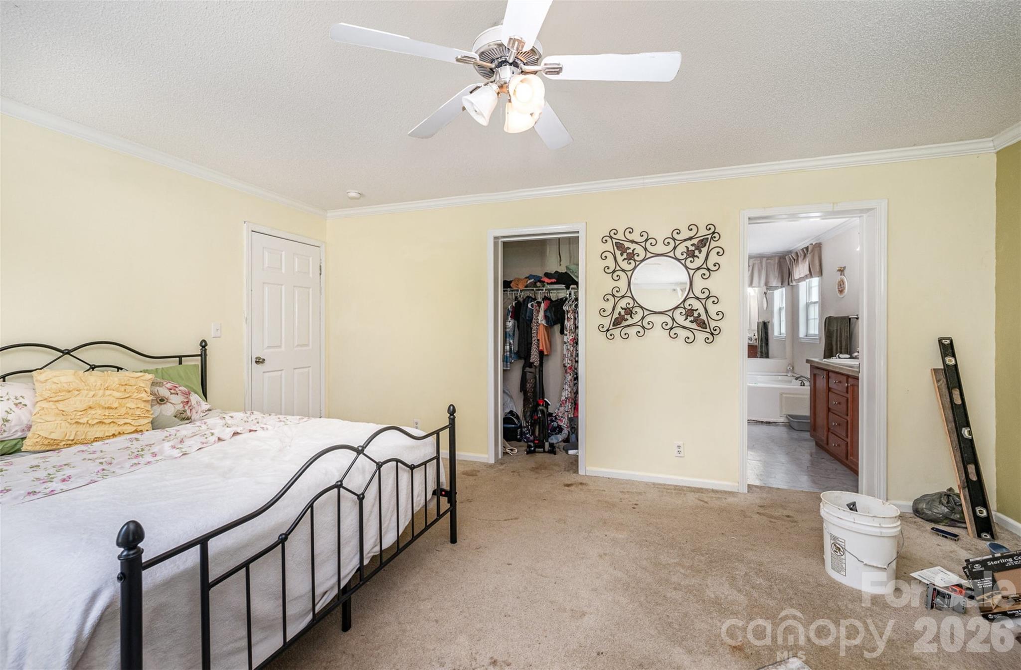 5602 Flint Ridge Marshville, NC 28103 - Photo 19 of 26 a bedroom with a bed and a walk in closet
