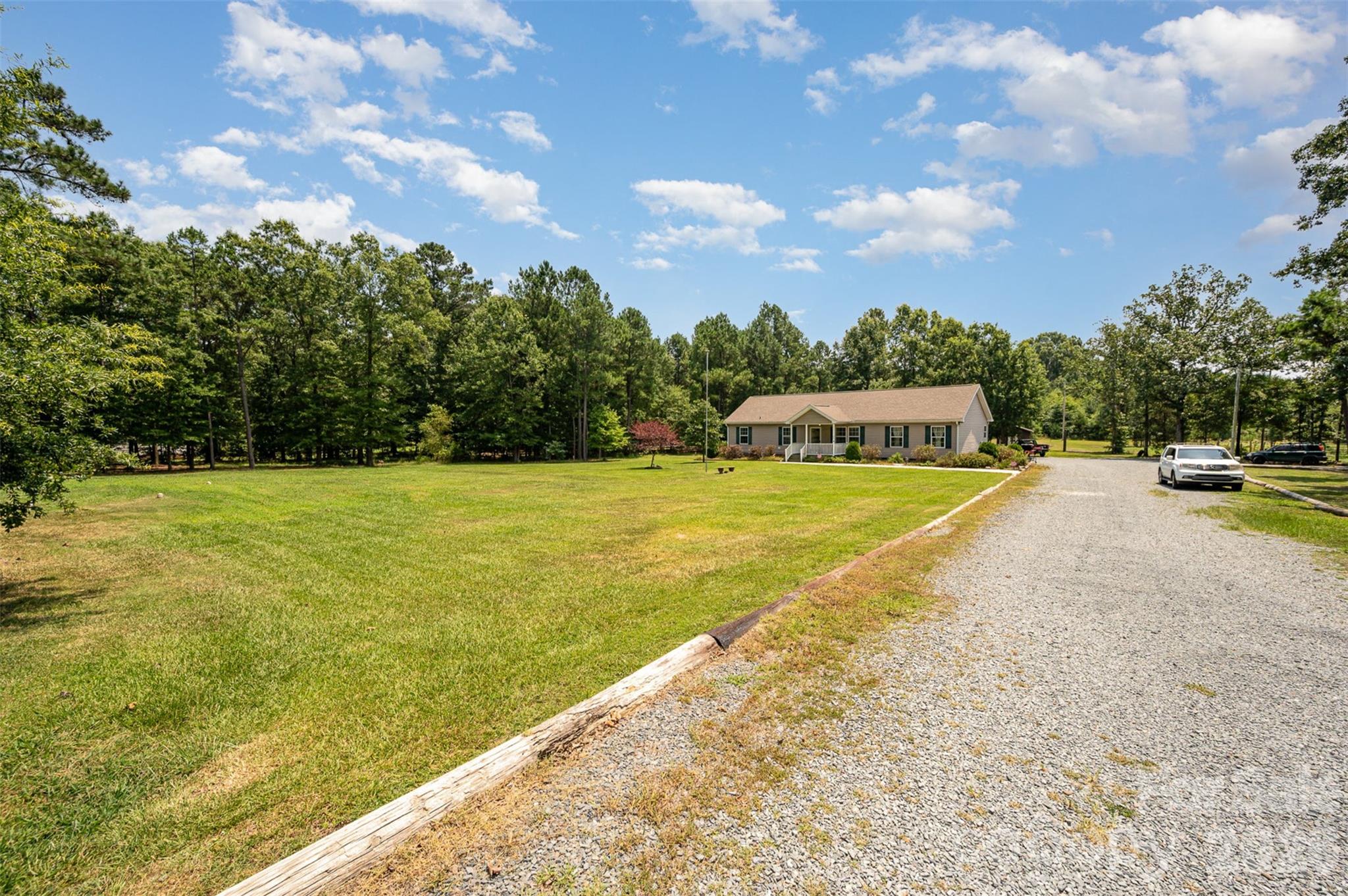 5602 Flint Ridge Marshville, NC 28103 - Photo 2 of 26 a view of a swimming pool with an outdoor seating and a yard