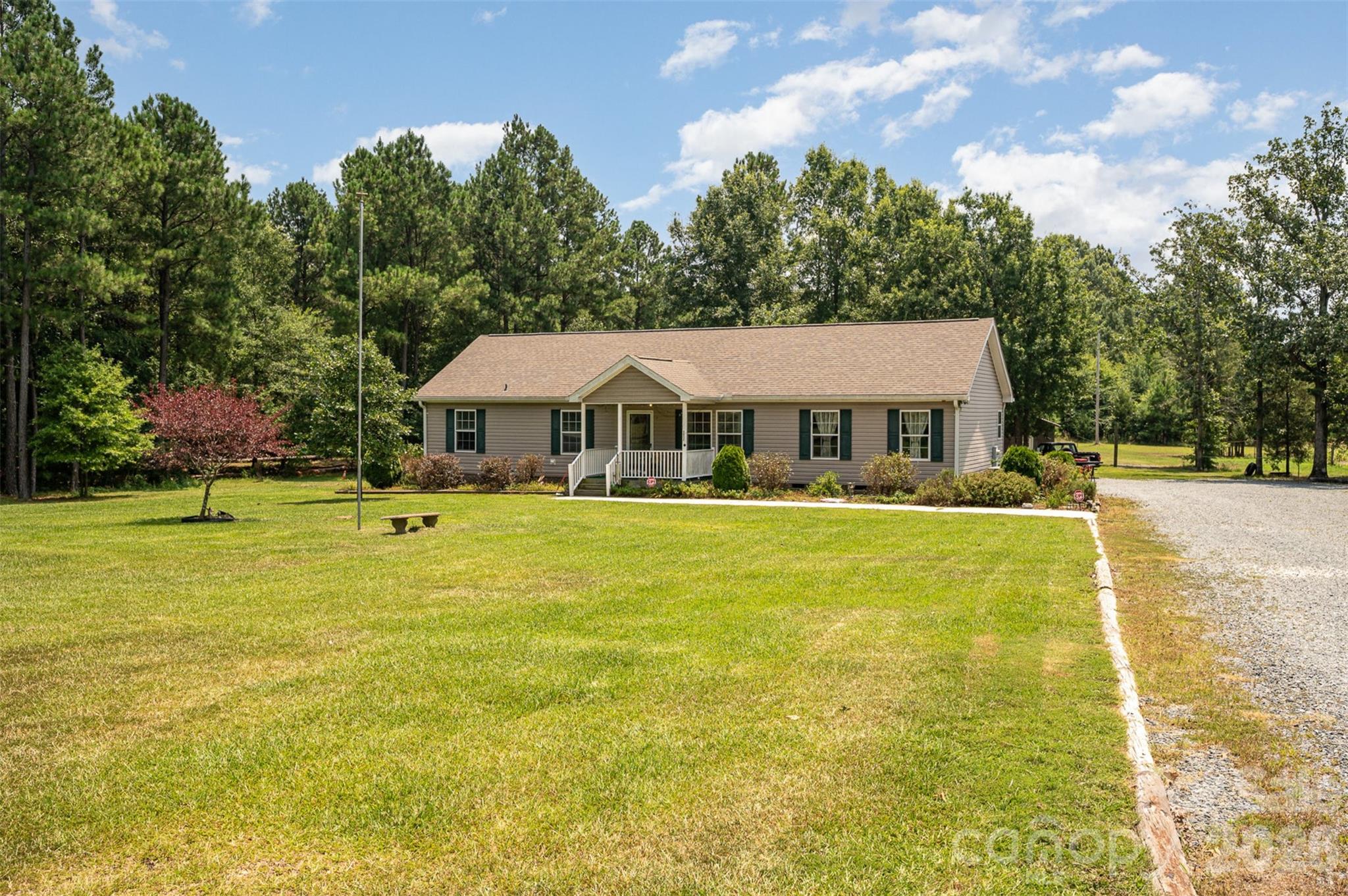 5602 Flint Ridge Marshville, NC 28103 - Photo 3 of 26 a front view of house with swimming pool and green space