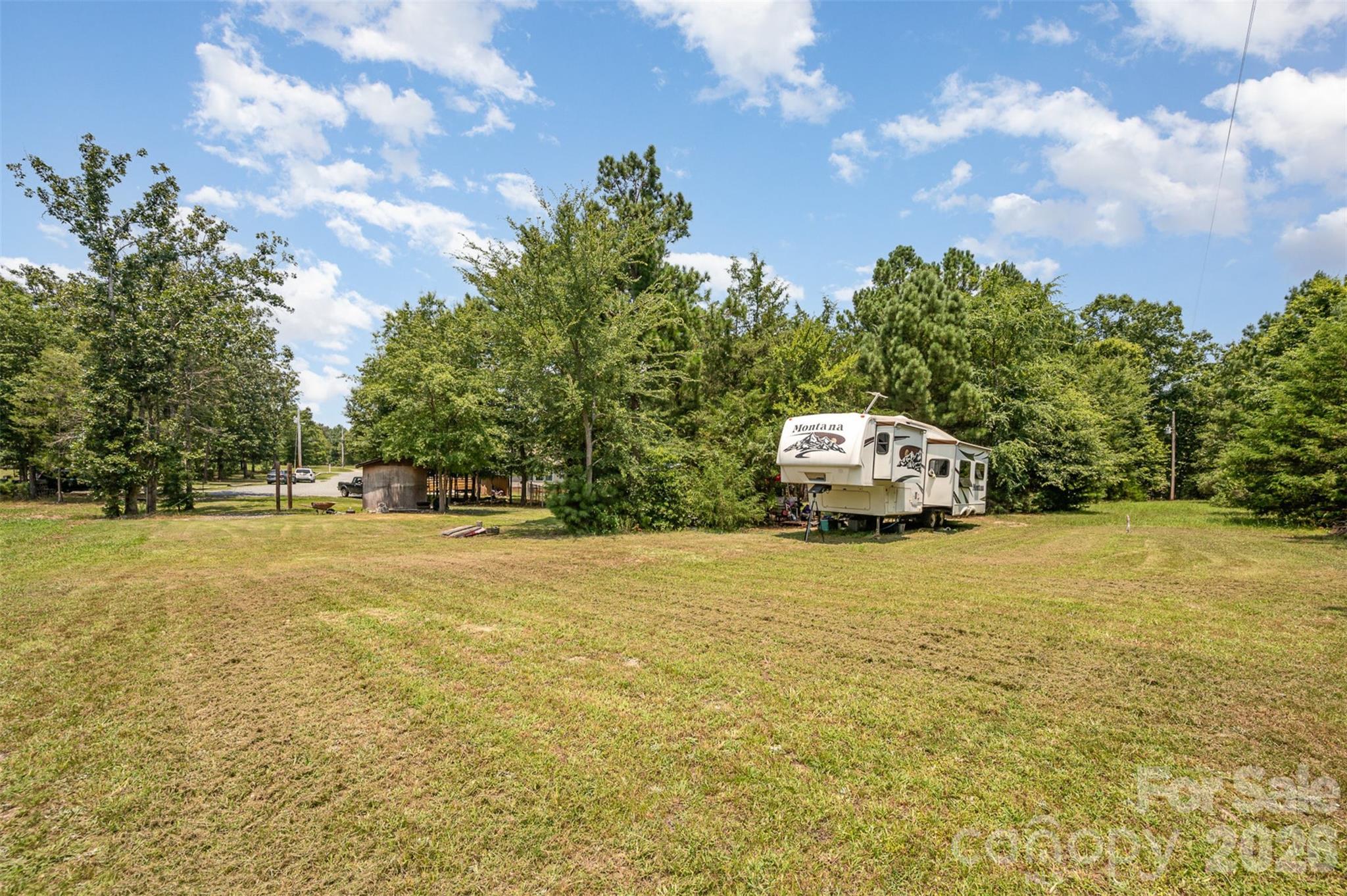 5602 Flint Ridge Marshville, NC 28103 - Photo 8 of 26 a house view with swimming pool and trees in the background
