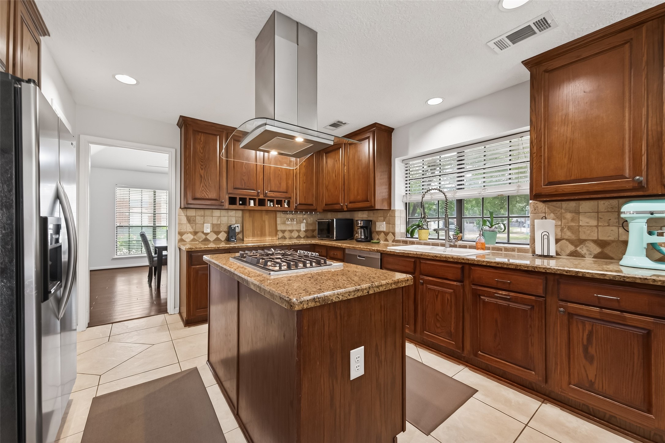 18526 Fawn Run Lane Houston, TX 77084 - Photo 11 of 47 Spacious kitchen with center island, granite countertops, stainless steel appliances, and recessed lighting, ideal for meal prep and gathering.