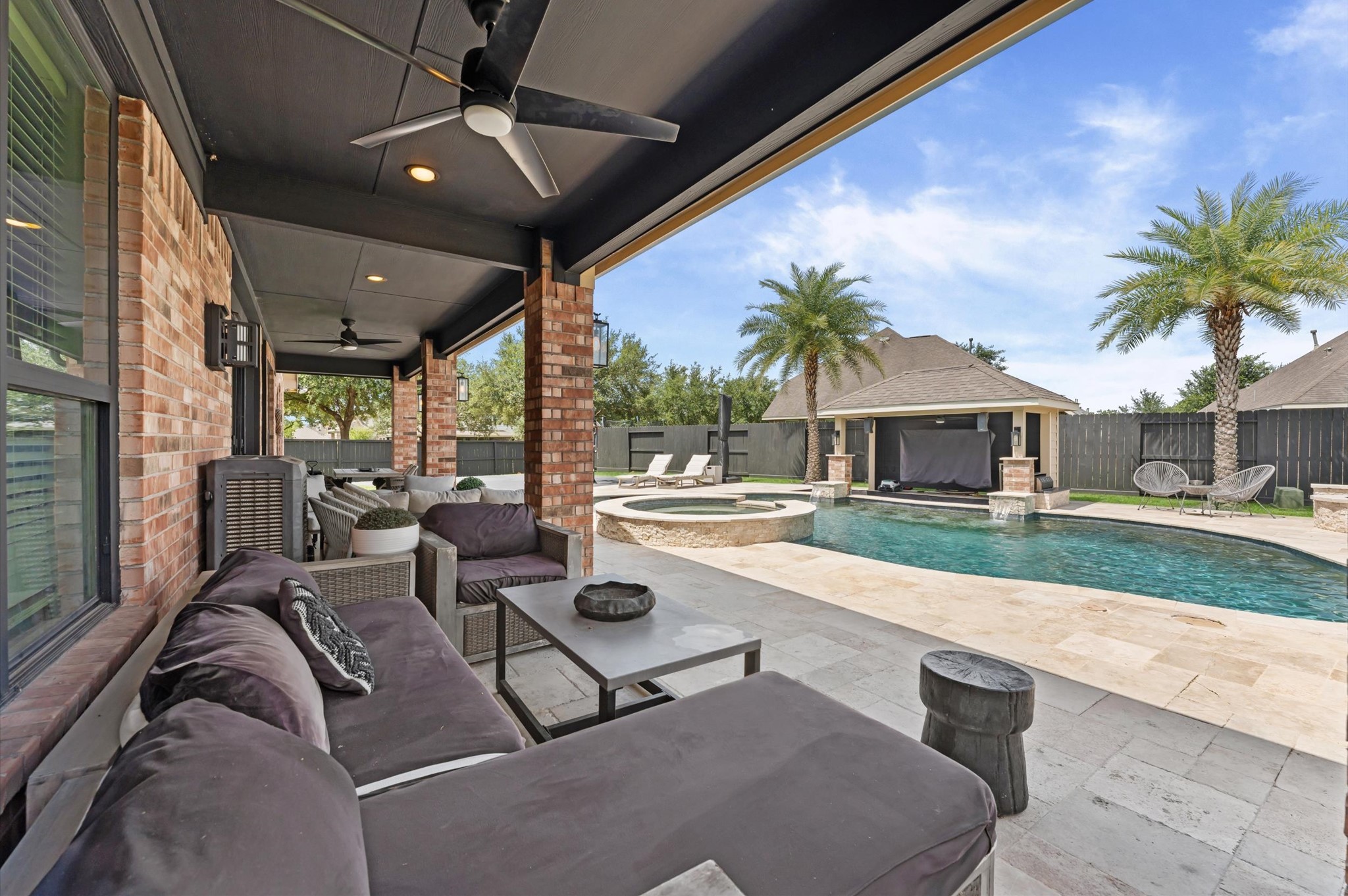 14016 Savannah Landing Lane Rosharon, TX 77583 - Photo 39 of 49 a view of a patio with couches and table and chairs under an umbrella