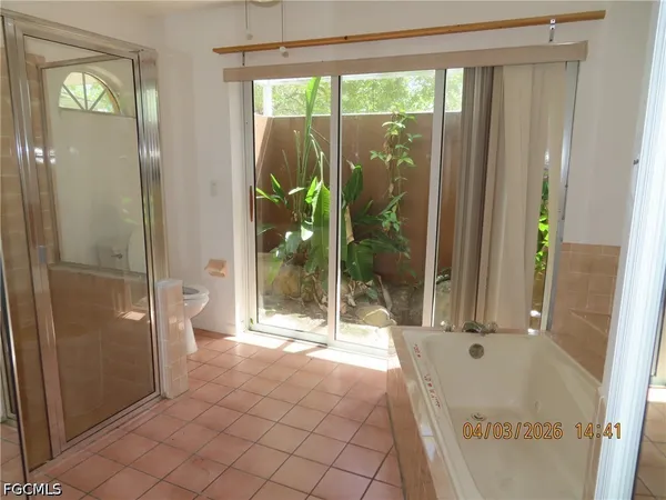 a bathroom with a tub and shower