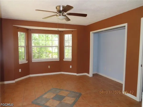 a view of room with a ceiling fan and a window