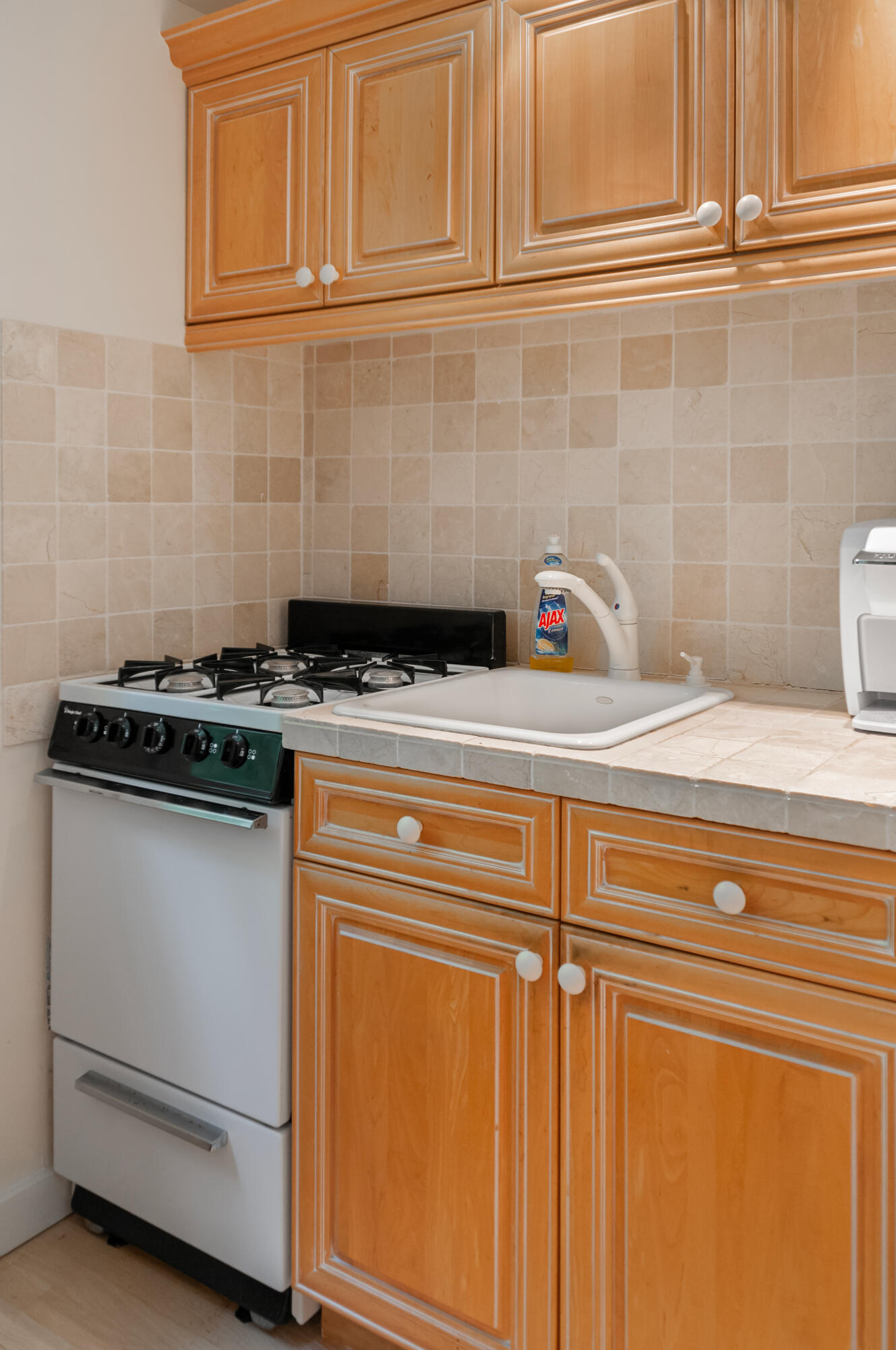 23 Paula Lane Cotuit, MA 02635 - Photo 15 of 23 a kitchen with granite countertop cabinets a stove and a microwave oven