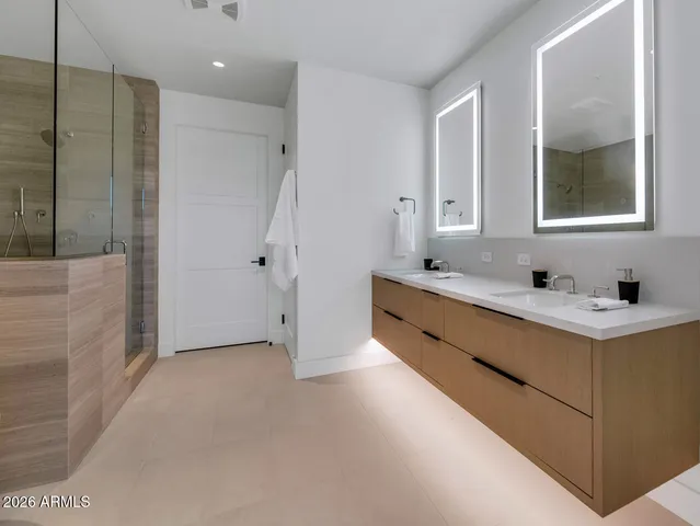 a bathroom with a double vanity sink mirror and double
