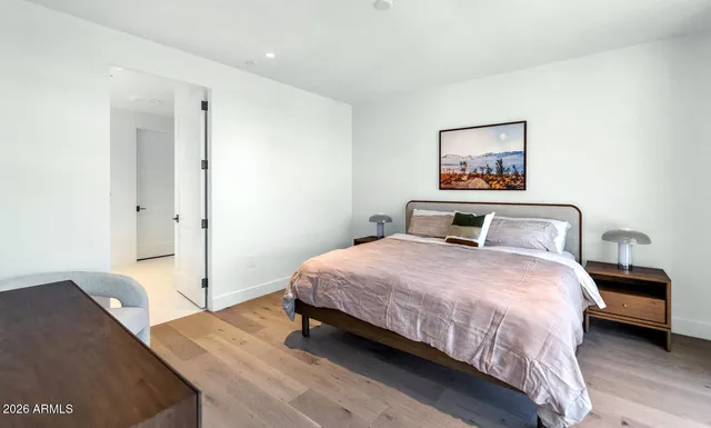 a bedroom with a bed and a painting on the wall