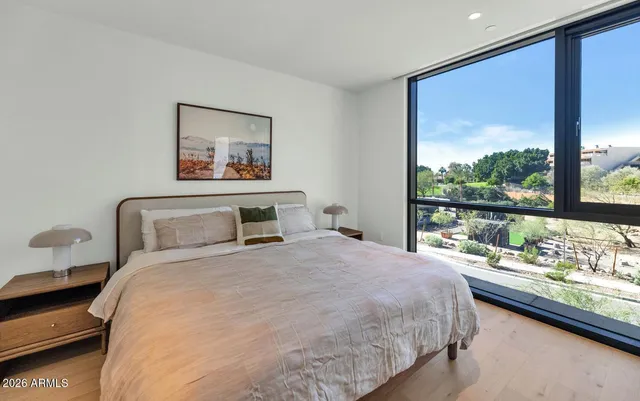 a bedroom with a large bed and a large window