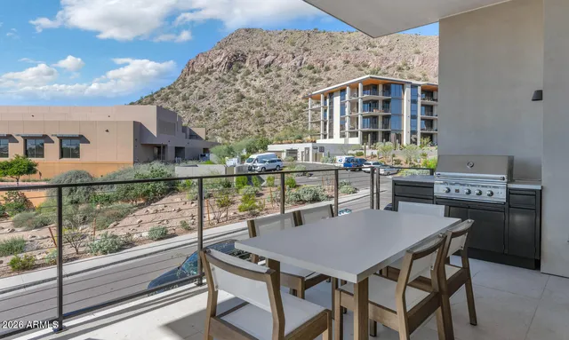 a view of a patio with a table and chairs