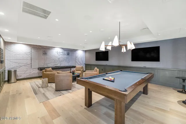 a living room with a flat screen tv and gym equipment