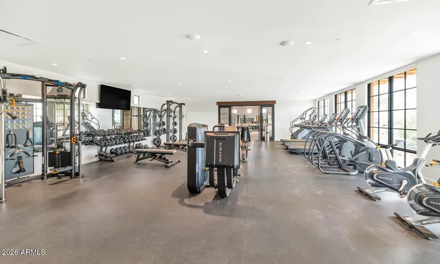 a view of a livingroom with workspace and windows