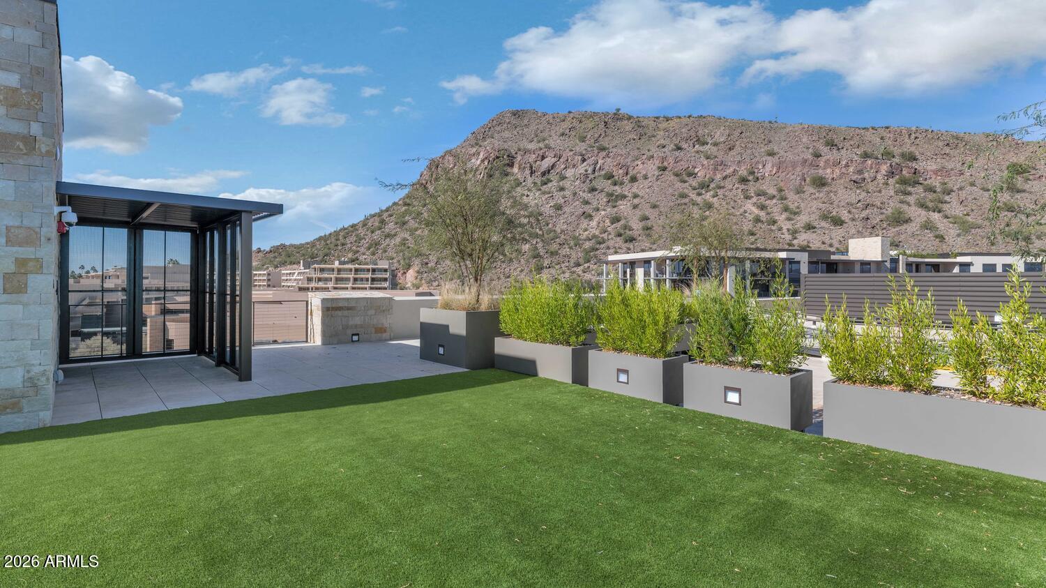 4849 North Camelback Ridge Road, Unit B203 Scottsdale, AZ 85251 - Photo 27 of 30 a view of a house with a yard and a pond