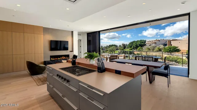 a living room with furniture a flat screen tv and a floor to ceiling window