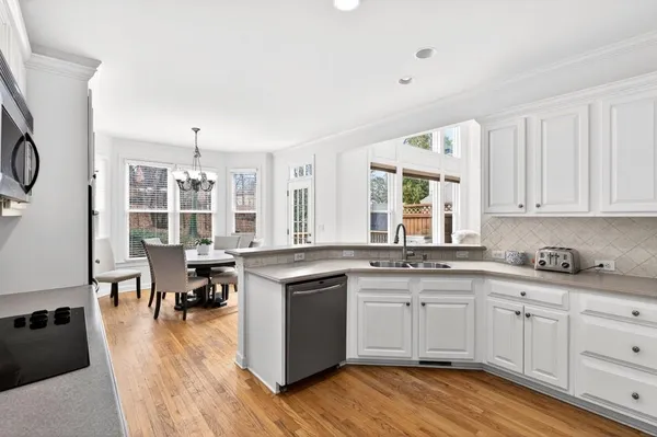a kitchen with stainless steel appliances a sink a stove and a refrigerator