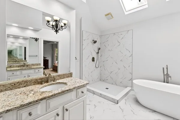 a white toilet sitting next to a bathroom sink
