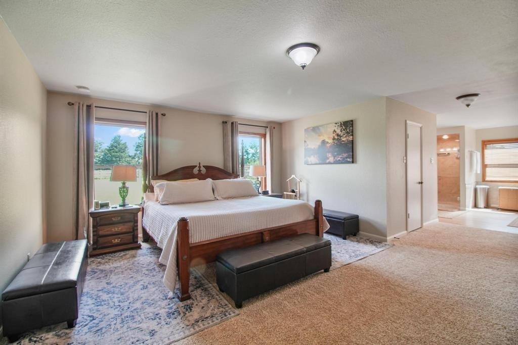 11074 State Highway 64 Overton, TX 75684 - Photo 11 of 40 a bedroom with a bed lamp and a large window