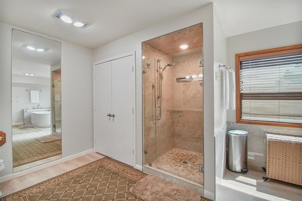 11074 State Highway 64 Overton, TX 75684 - Photo 12 of 40 a bathroom with a shower and a glass door