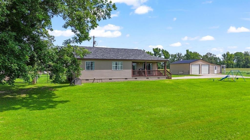 11074 State Highway 64 Overton, TX 75684 - Photo 17 of 40 a front view of a house with a garden