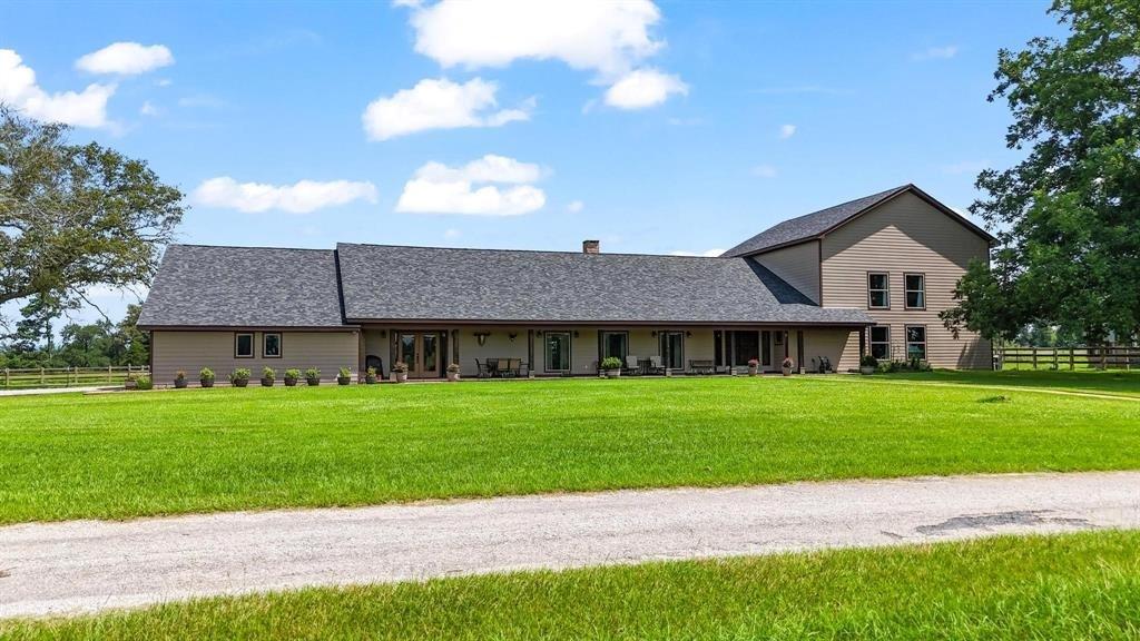 11074 State Highway 64 Overton, TX 75684 - Photo 2 of 40 a front view of a house with a garden and yard