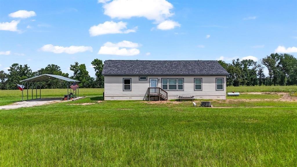 11074 State Highway 64 Overton, TX 75684 - Photo 22 of 40 a front view of a house with a yard