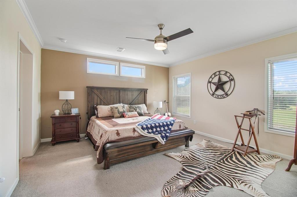 11074 State Highway 64 Overton, TX 75684 - Photo 25 of 40 a bedroom with a bed dresser and a window