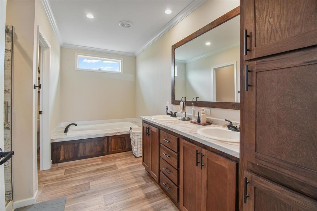 11074 State Highway 64 Overton, TX 75684 - Photo 26 of 40 a bathroom with a double vanity sink and a mirror